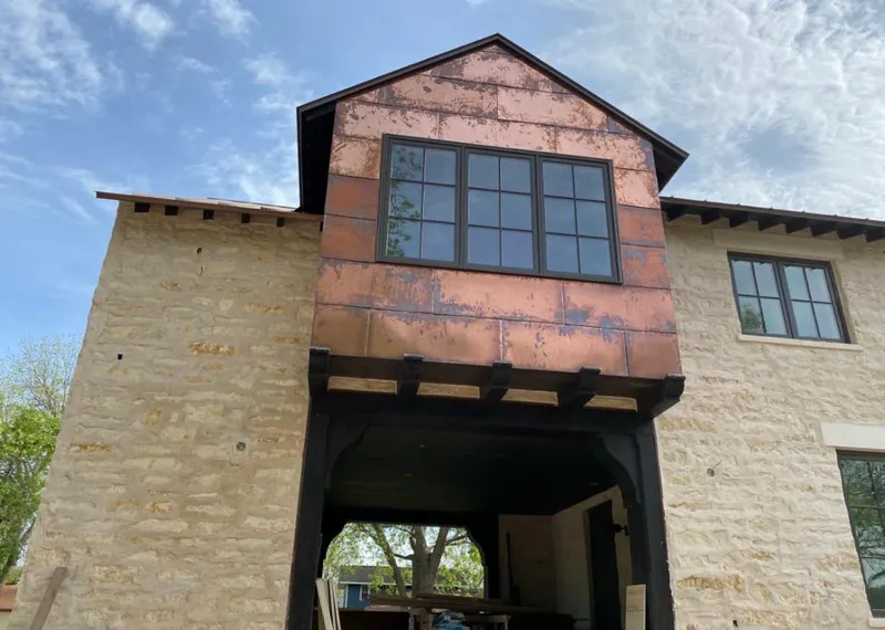 Copper metal panel facade on a stone building for Metal Roof Coating in Fresno