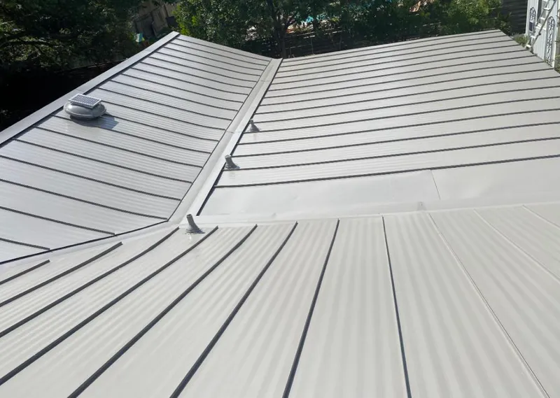 Solar attic fan installed on a metal roof for Roof Ventilation in Fresno